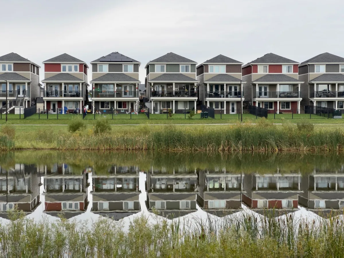 Row of homes reflected in water near the Cypress, TX area